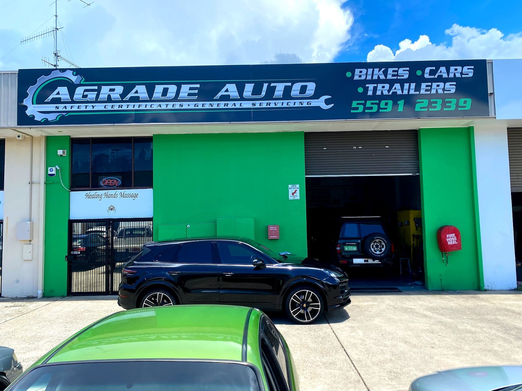 The AGRADE AUTO shopfront on Lawrence Drive, Nerang, with cars in the bay